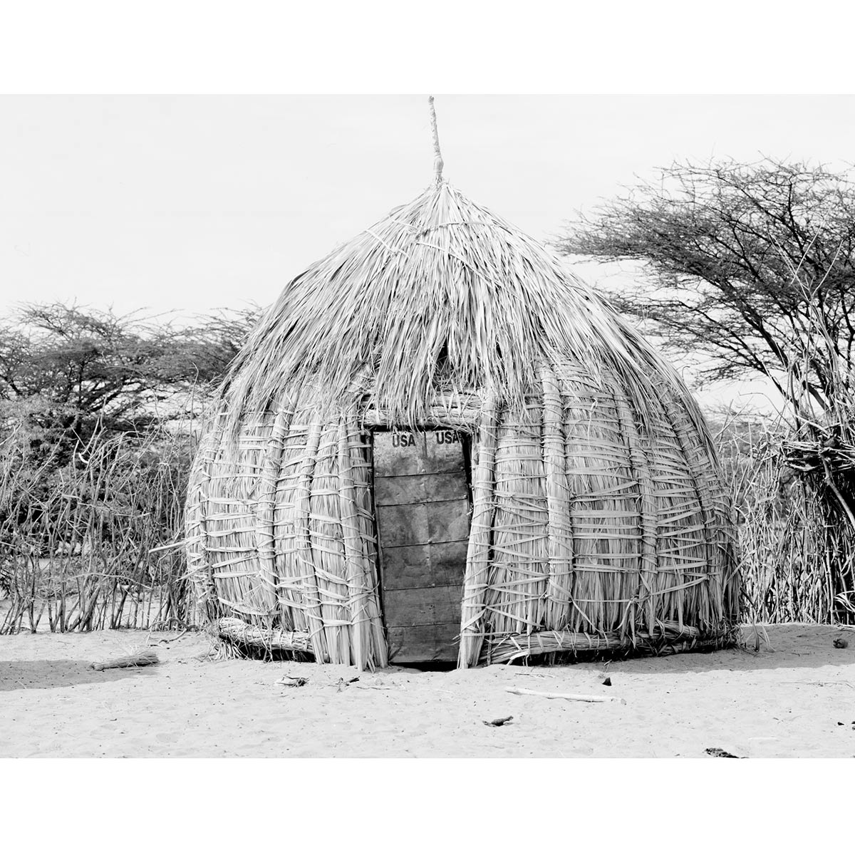 Winfried Bullinger - Hut with entrance door made from the remains of a container with the inscription ”USA”